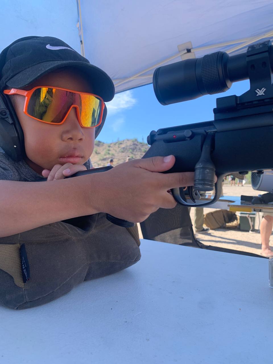 Trigger discipline in action — 5-year-old shooter sending rounds downrange with a suppressed 17 HMR
