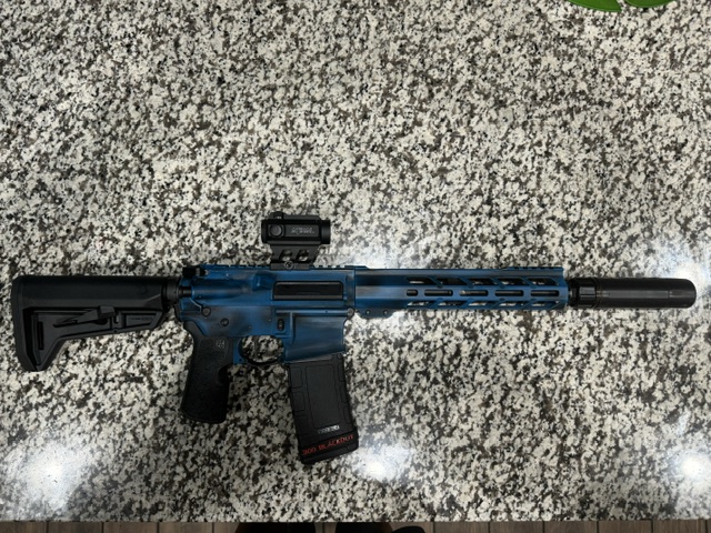 Blue cerakote AR-15 — suppressed with red dot and .300 BLK mag