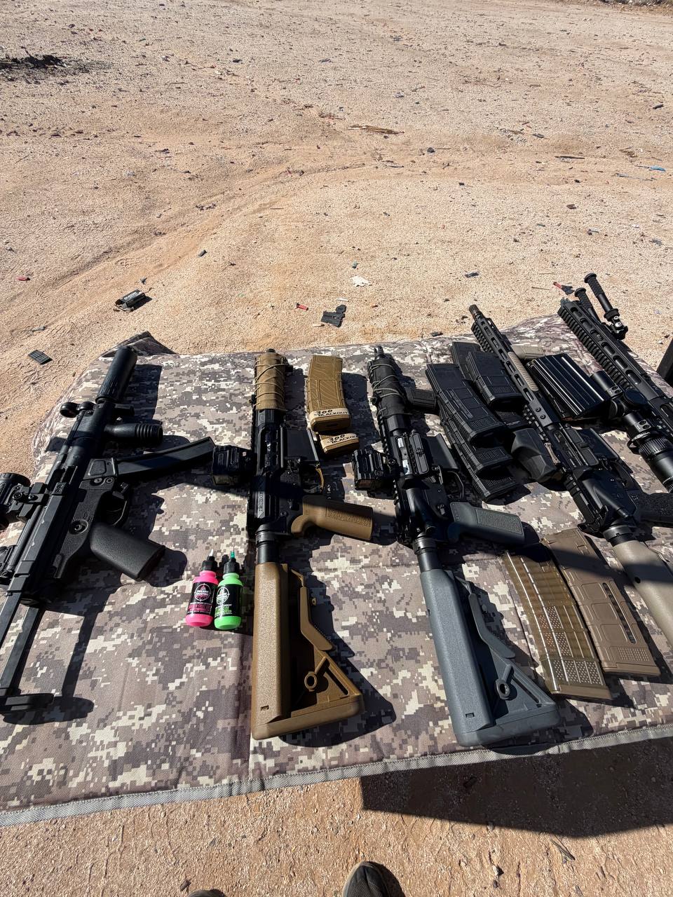 Full range day lineup — pistol caliber, 300 BLK, and AR platforms staged